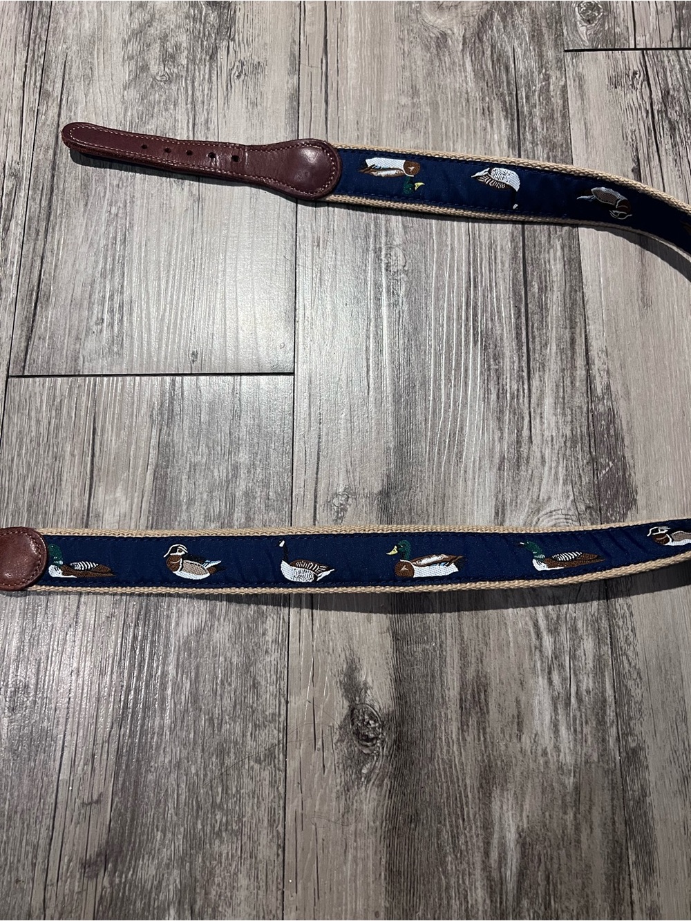 Navy blue duck print belt with brown leather trim